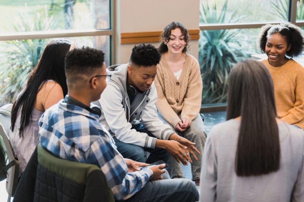 Group of people sitting and talking together.