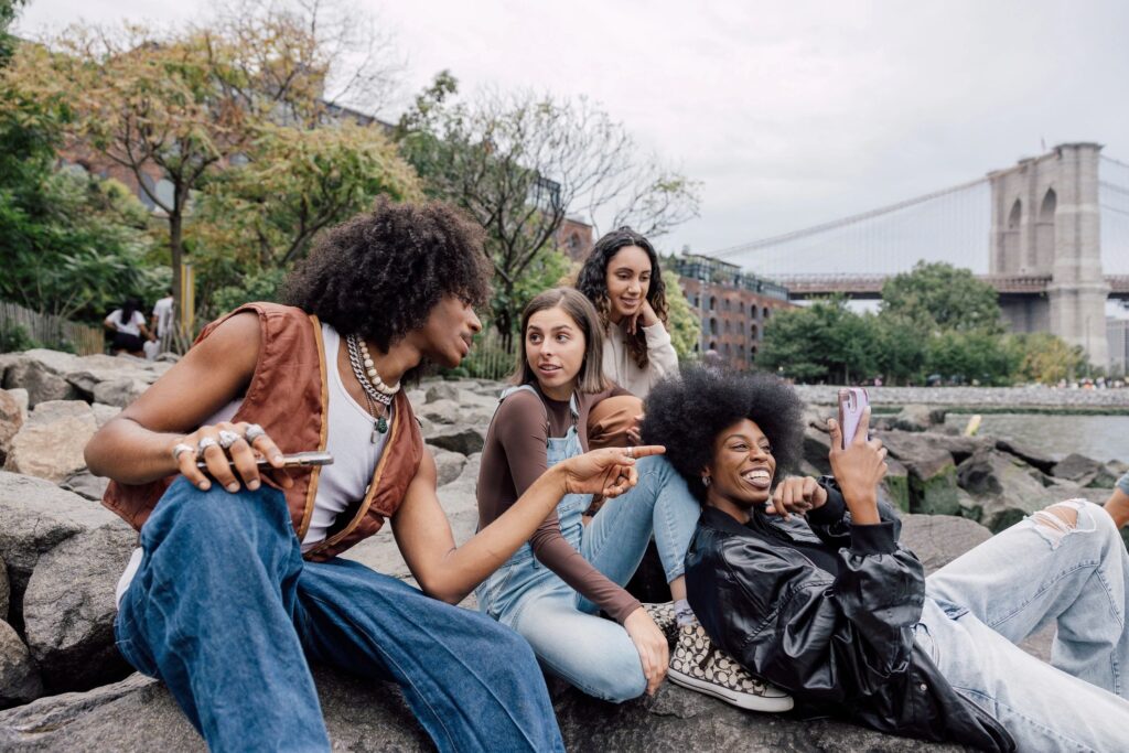 Four friends enjoying coffee and conversation outdoors.