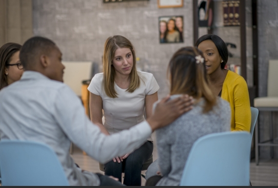 Group therapy session with supportive participants.