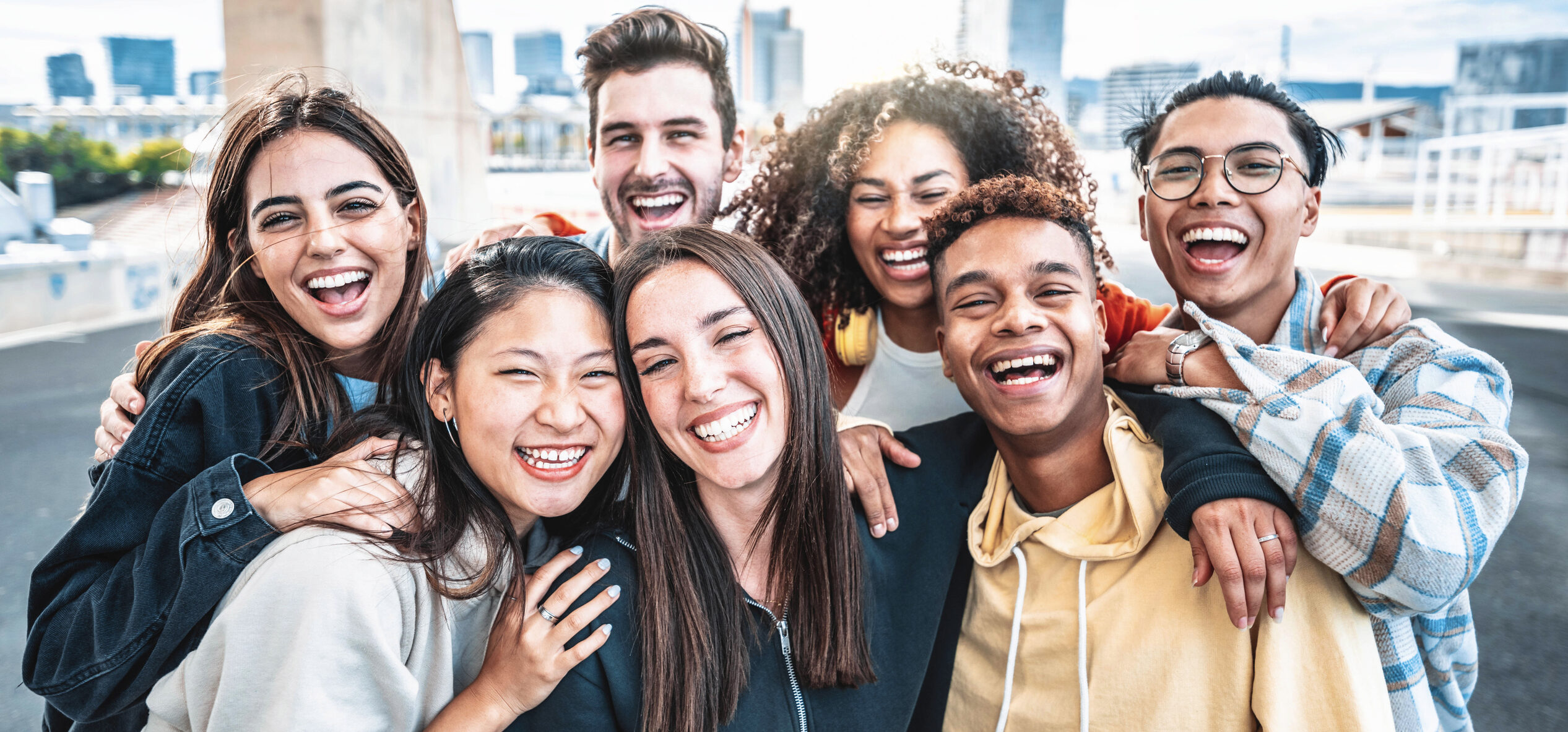Group of friends smiling outdoors together.